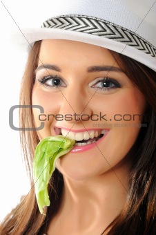 Young pretty woman eating green salad leaf . isolated on white