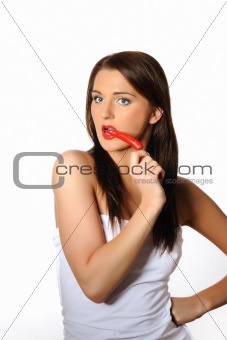 Beautiful sexy woman with red hot chilli pepper. isolated