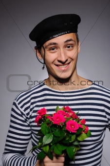 Funny emotional romantic sailor man holding rose flowers