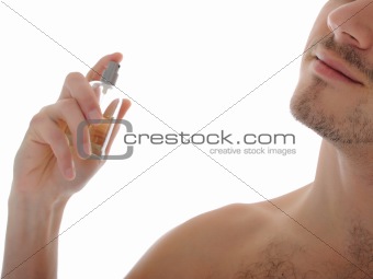macro shot young male spray perfume on his skin. isolated
