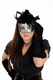 Beautiful brunette woman in black dress in party carnival mask .