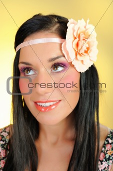 Young beautiful woman face with creayive eye make-up and flower 