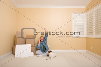 Pretty Woman on the Floor Using Phone Celebrating with Moving Boxes, Blank Signs and Dog in Empty Room.