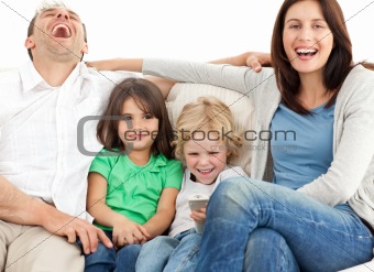 Portrait of a family on the sofa while watching television