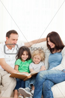 Cheerful family looking at a photo album together