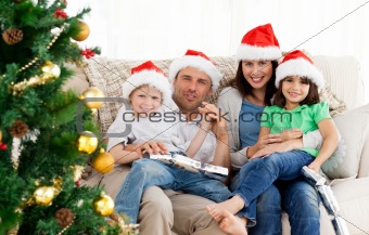 Portrait of a family at Christmas on the sofa
