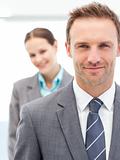 Confident businesswoman and businessman posing together in line