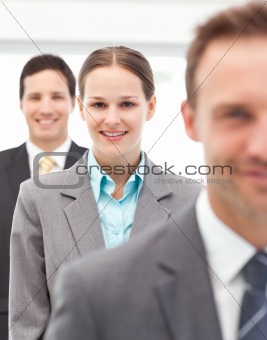 Happy businesswoman standing in a row with her two partners 
