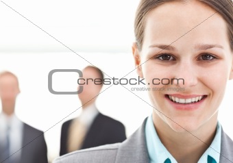 Young businesswoman posing in front of two businessmen