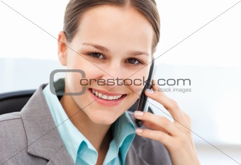 Female executive using her cellphone at her desk