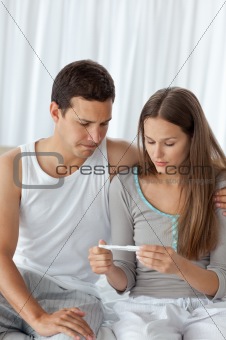 Young couple waiting for the result of the pregnancy test