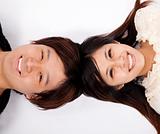 Happy asian couple laying on white floor