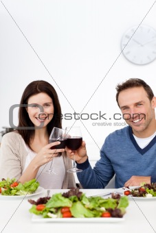 Lovely couple drinking red wine while having lunch