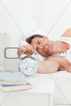 A unhappy man in his bed before waking up 