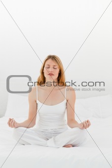 Woman practice yoga on her bed