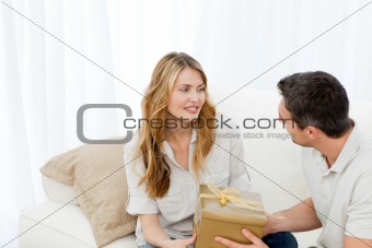 Man offering a gift to his wife