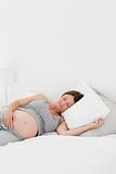 Pregnant woman on her bed 