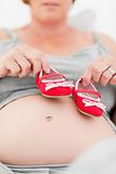 Pregnant woman with kids shoes