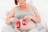Pregnant woman with kids shoes