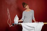 young woman ironing a shirt