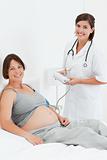 Pregnant woman with a nurse smilling