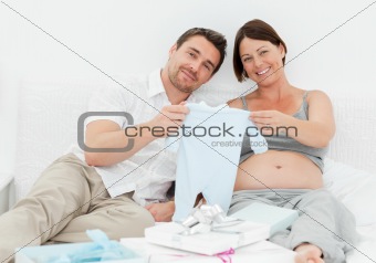 Young futur parents with chlidrens clothes