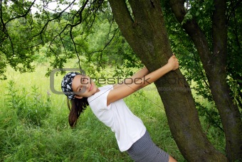 Teenage girl by tree