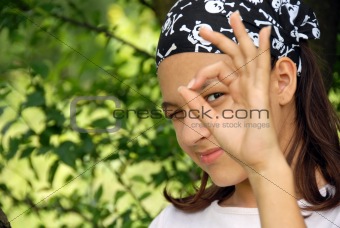 Teenage girl looking through ok sign