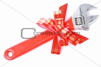 Wrench with red plastic handle and red bow as a gift for handyman