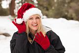 Attractive Santa Hat Wearing Blond Woman Having Fun in The Snow on a Winter Day.