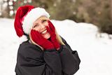 Attractive Santa Hat Wearing Blond Woman Having Fun in The Snow on a Winter Day.