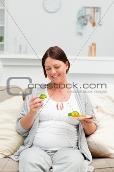 Pregnant woman eating vegetables