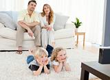 Adorable family watching tv