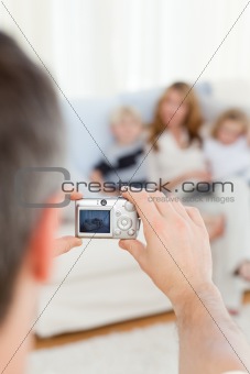 Man taking a photo of his family