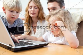 Family looking at their laptop