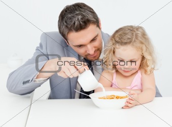 Father having breakfast with her daughter