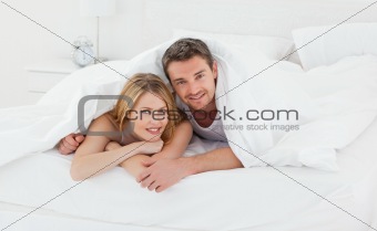 Lovely couple in their bed in their bedroom