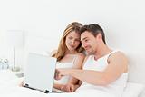 Lovers watching a movie on their laptop