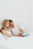 Lovers watching a movie on their laptop