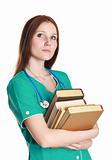 Portrait of kind female nurse in the green uniform with books