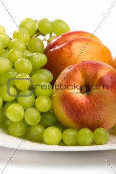Grapes and peaches on a white background