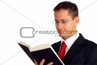 Young man in a suit reading a book