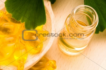ginko biloba essential oil with fresh leaves - beauty treatment