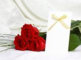 Beautiful red roses and invitation card