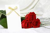 Beautiful red roses and invitation card