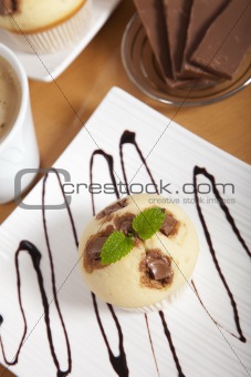 Delicious chocolate muffin on a decorated plate