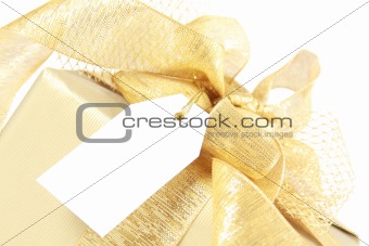 Golden christmas gift box with blank tag 
