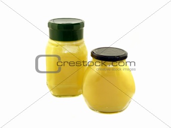 Butter melted in a glass jar in isolation on a white background 