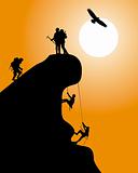 Silhouette of a rock with climbers