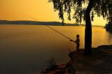 fishing on shoreline at dusk 